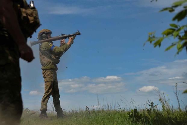 A Ukrainian soldier fires an RPG at Russian lines.