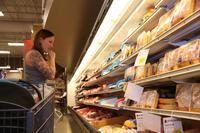 A Cooking Matters tour participant looks at heath-food options