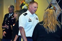 Col. John Schroeder, commander of the Wisconsin National Guard's 157th Maneuver Enhancement Brigade, and Capt. Joseph Ledger, manager of the Wisconsin Employment Resources Connection, speak with attendees during a symposium on hiring veterans.