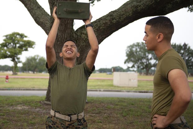 Marine lifts a 30-pound ammunitions can during his combat fitness test.