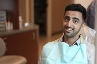 Abdul Wasi Safi waits for the start of his dental appointment during a clinic visit