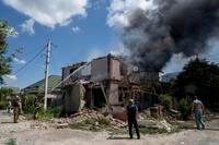 Ukrainian State Emergency Service firefighters put out a house fire. 