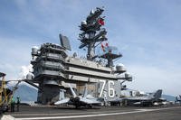 United States and Vietnam national ensigns are raised in unison on the USS Ronald Reagan (CVN 76) in Da Nang, Vietnam