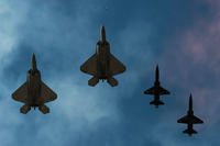 F-22 Raptors and T-38 Talons perform a fly over