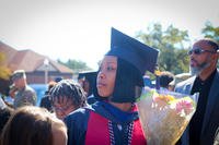 A sergeant first class holds a bouquet of roses after the Fort Knox Army Education Center College Graduation Ceremony.