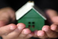 Green house in hands.