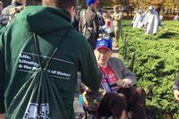 Leland Thomas, 87, receives handshakes from children at the Korean War Memorial on Nov. 8, 2018. Thomas served in both Korea and Vietnam as a combat cameraman, and conducted interviews with prisoners of war. (Oriana Pawlyk/Military.com)