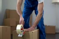 A man tapes a box