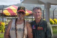 A Marine Corps veteran and Marine Corps Colonel smile in America Samoa. 