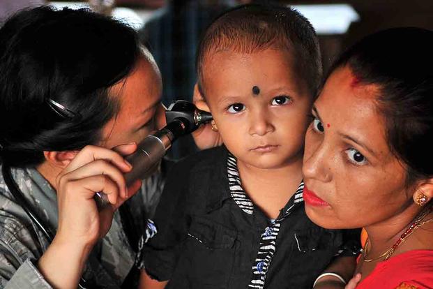 U.S. Air Force Capt. (Dr.) Enrilyn Thronson, Operation Pacific Angel-Nepal pediatrician, examines a patient at a health services outreach site in Manahari, Nepal. (U.S. Air Force/Staff Sgt. Melissa B. White)