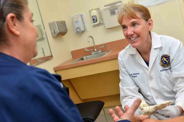 Cmdr. Deborah Robinson, a podiatrist at Naval Branch Health Clinic (NBHC) Mayport, conducts a plantar fasciitis foot exam. ( (U.S. Navy/Jacob Sippel)