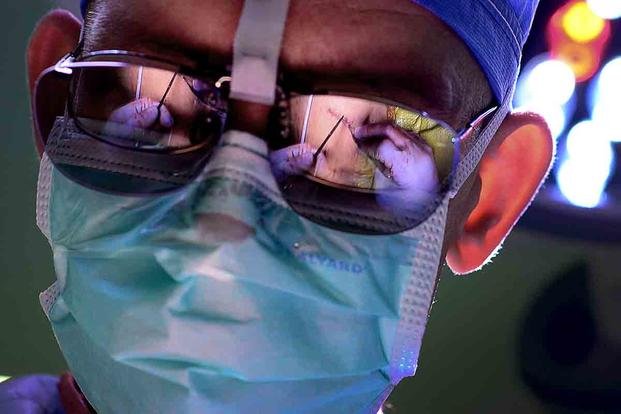 U.S. Air Force Major Richard Knight, Diplomate of the American Board of Urology, Chief of Surgery at the 48th Medical Group, makes the final sutures on a patient during a laparoscopic radical prostatectomy surgery using FlexDex technology. (U.S. Air Force/Tech. Matthew Plew)