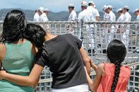 Military family watches deployment.