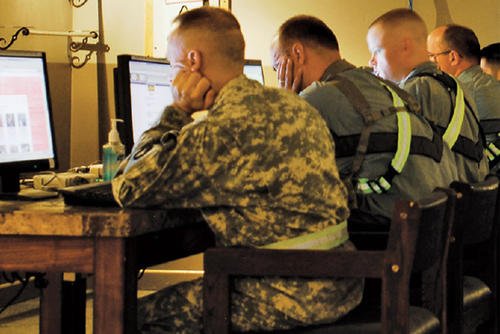 Service members using computers.