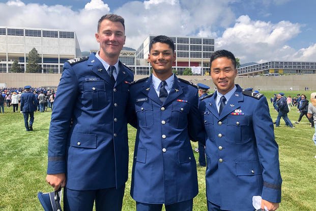 Baseball players Paul Skenes, Sam Kulasingam and Aerik Joe pose in their military uniforms.