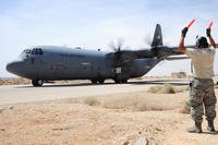 Staff Sgt. Willeams Roldan, 146th Aircraft Maintenance Squadron crew chief, marshals a C-130J Hercules for takeoff during Exercise Eager Lion May 29, 2014.