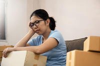 A woman sits with boxes during a PCS.