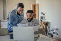 A couple examines VA home loan paperwork.