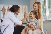 Mother and daughter with female doctor