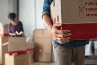 A man carries a box during a military PCS move. 