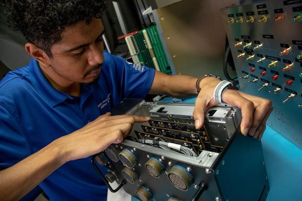 SwRI employee working on computer hardware